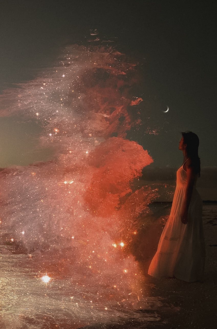 Woman in white on a moonlit shore beside a wave of glittering light