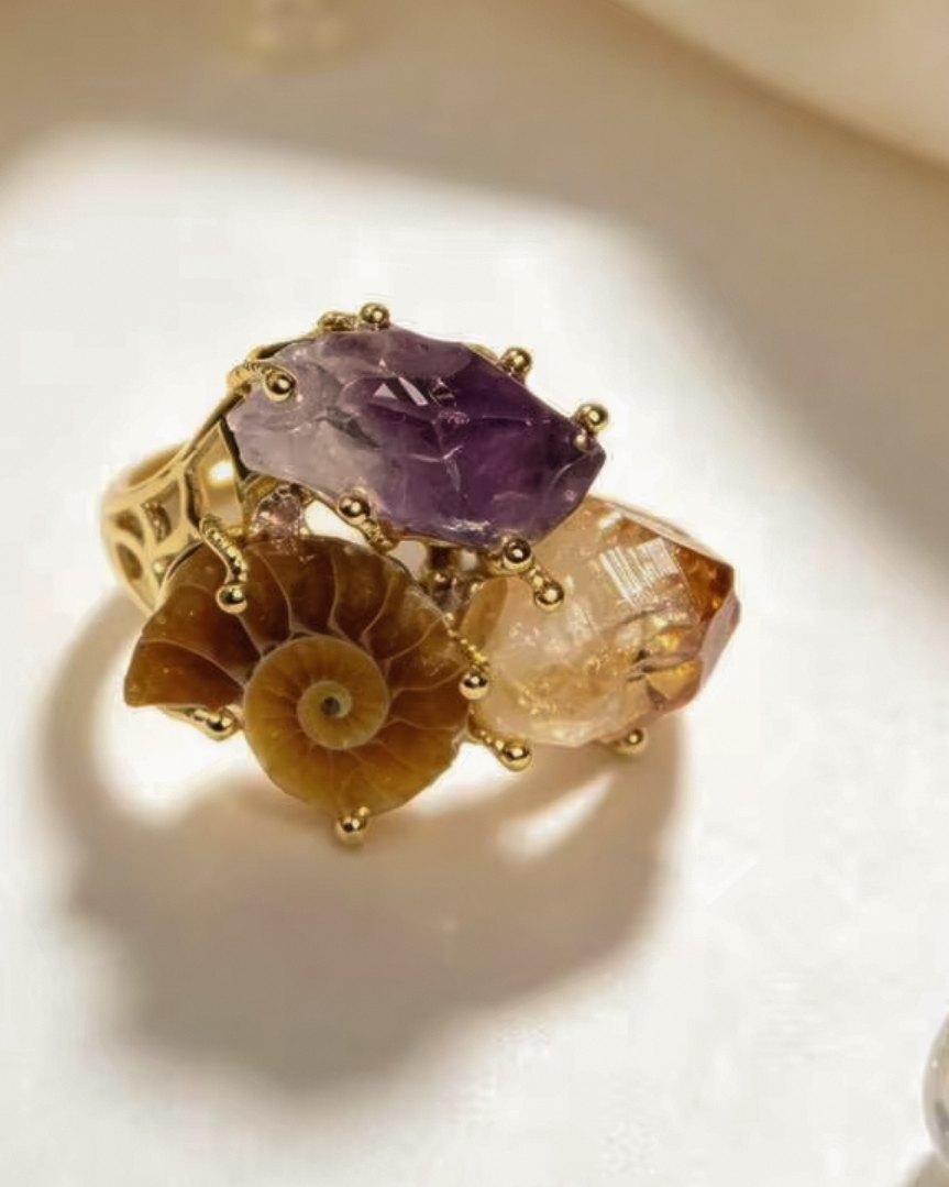 Vesper — raw crystal ring with violet, amber and spiral-patterned natural stones in a gold-toned setting